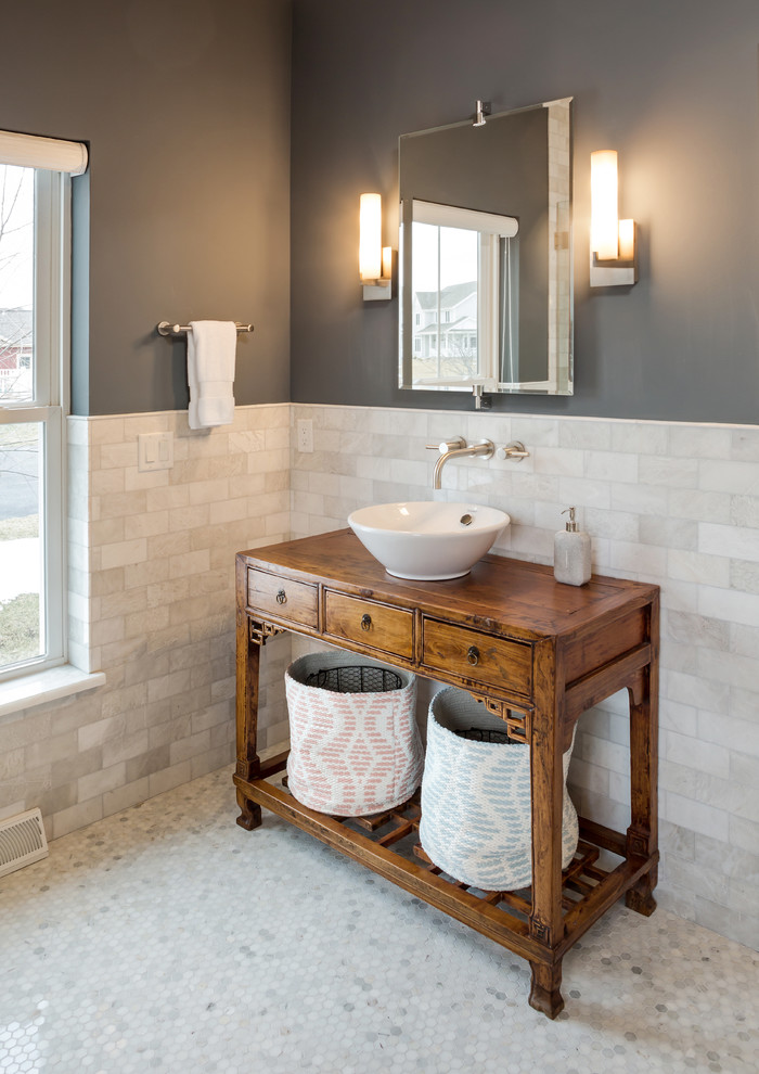 Design ideas for a medium sized rural bathroom in Milwaukee with a vessel sink, medium wood cabinets, wooden worktops, a freestanding bath, a corner shower, a one-piece toilet, beige tiles, ceramic tiles, grey walls and ceramic flooring.