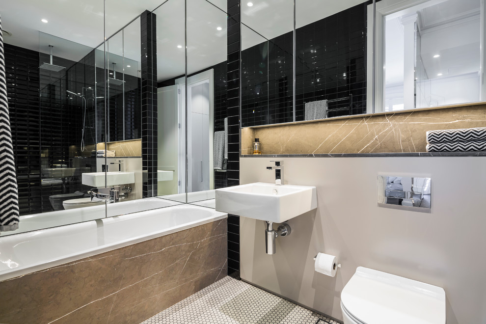 シドニーにある中くらいなコンテンポラリースタイルのおしゃれなマスターバスルーム (ドロップイン型浴槽、オープン型シャワー、壁掛け式トイレ、黒いタイル、セラミックタイル、壁付け型シンク、白い床、オープンシャワー、ベージュの壁、モザイクタイル) の写真