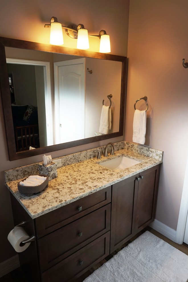 Inspiration for a medium sized classic ensuite bathroom in Miami with shaker cabinets, dark wood cabinets, medium hardwood flooring, a submerged sink, granite worktops, brown floors, an alcove shower, a two-piece toilet, ceramic tiles, beige walls and a hinged door.