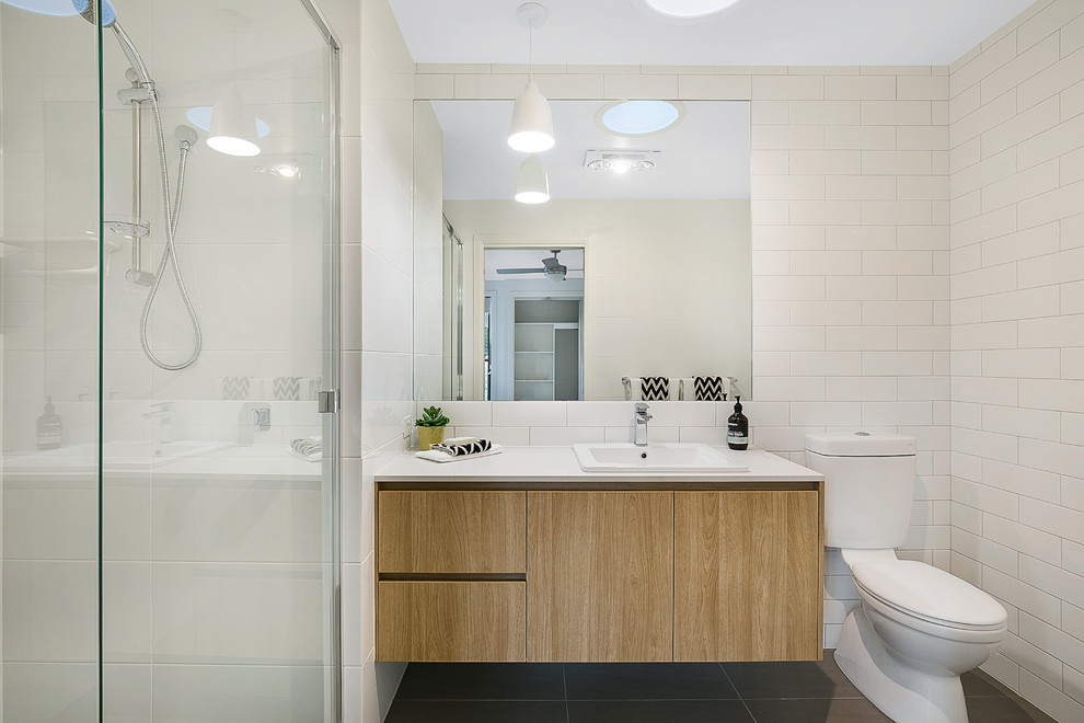 Inspiration for a contemporary shower room bathroom in Brisbane with flat-panel cabinets, light wood cabinets, a two-piece toilet, white walls and a built-in sink.
