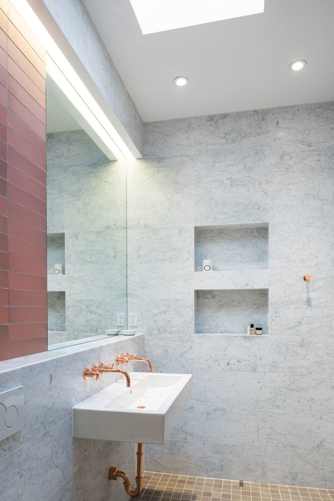 Inspiration for a mid-sized contemporary master white tile and stone tile ceramic tile doorless shower remodel in New York with white walls and a trough sink
