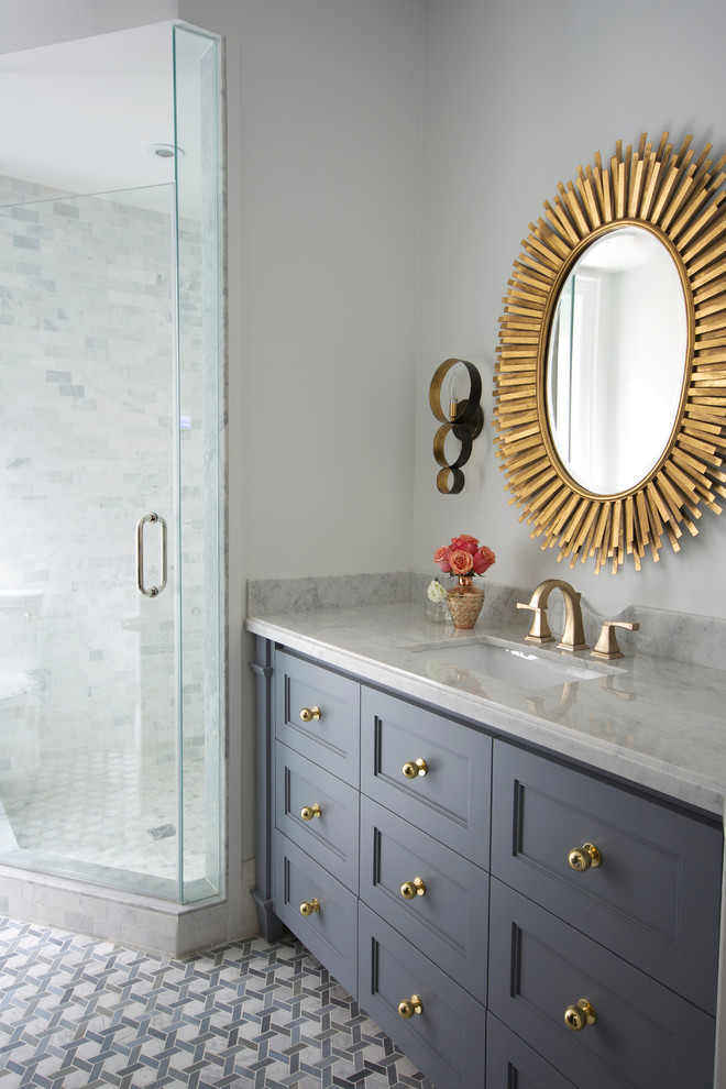 Photo of a medium sized traditional ensuite bathroom in Toronto with a submerged sink, recessed-panel cabinets, grey cabinets, marble worktops, a corner shower, a one-piece toilet, blue tiles, mosaic tiles, white walls and marble flooring.