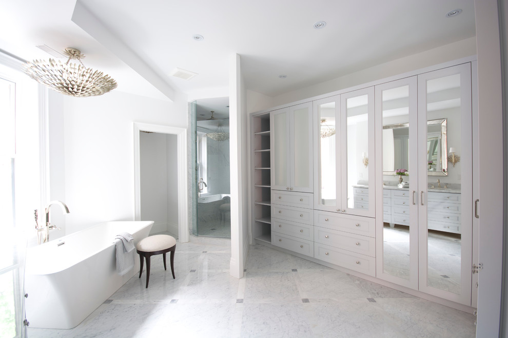 This is an example of a large classic ensuite bathroom in Toronto with a submerged sink, recessed-panel cabinets, grey cabinets, marble worktops, a freestanding bath, a corner shower, a one-piece toilet, grey tiles, stone tiles, white walls and marble flooring.