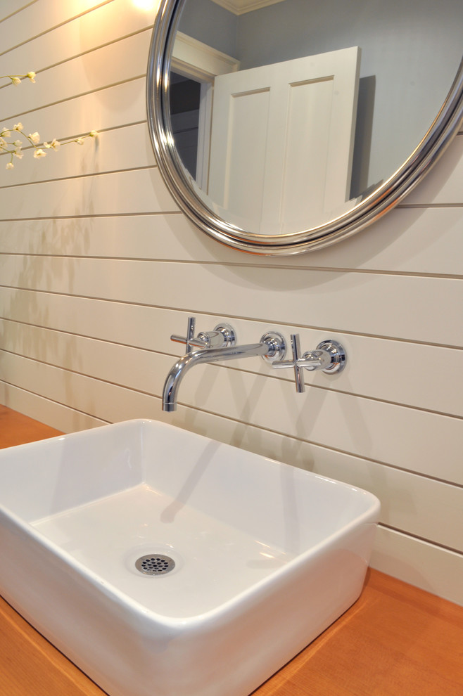 Example of a large minimalist 3/4 terra-cotta tile and beige floor bathroom design in Seattle with raised-panel cabinets, white cabinets, a one-piece toilet, white walls, a pedestal sink and wood countertops