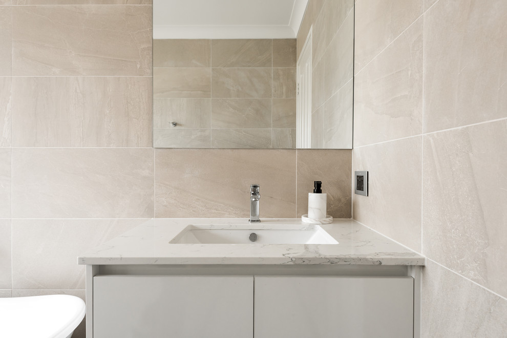 Medium sized mediterranean ensuite bathroom in Perth with flat-panel cabinets, white cabinets, a freestanding bath, a walk-in shower, a one-piece toilet, beige tiles, porcelain tiles, beige walls, porcelain flooring, a submerged sink, engineered stone worktops, grey floors and an open shower.