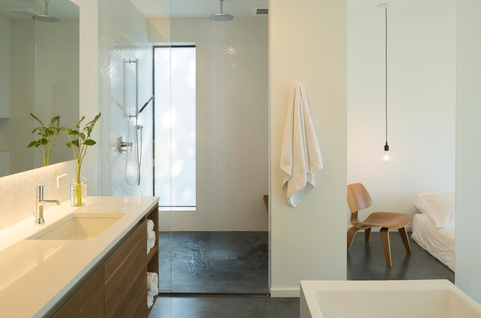 Inspiration for a medium sized contemporary ensuite bathroom in Seattle with flat-panel cabinets, medium wood cabinets, a freestanding bath, a built-in shower, a two-piece toilet, white tiles, white walls, concrete flooring, a submerged sink and engineered stone worktops.