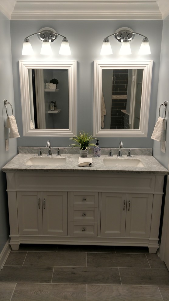 Example of a mid-sized classic master gray tile and glass tile ceramic tile and gray floor bathroom design in Cincinnati with furniture-like cabinets, white cabinets, blue walls, an undermount sink and granite countertops