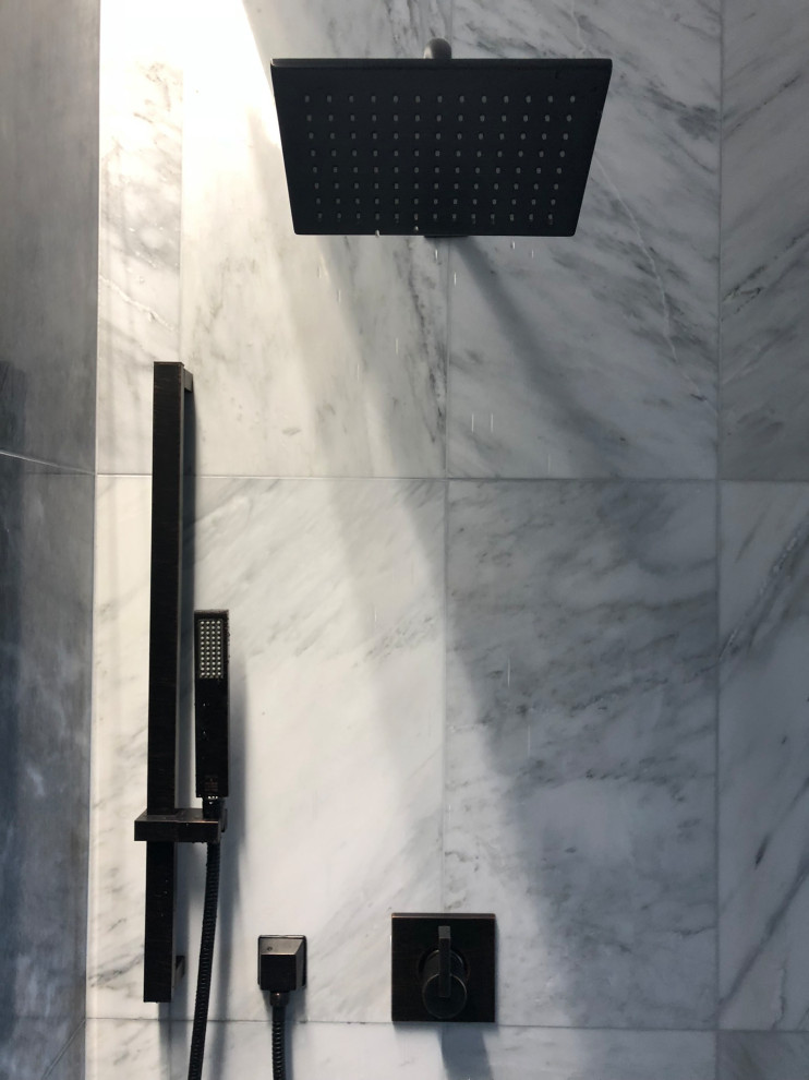 Urban bathroom in New York with marble tiles.