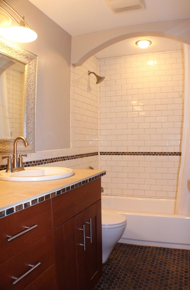 Medium sized classic shower room bathroom in Seattle with mosaic tile flooring, beige walls, an alcove bath, a shower/bath combination, a built-in sink, shaker cabinets and medium wood cabinets.
