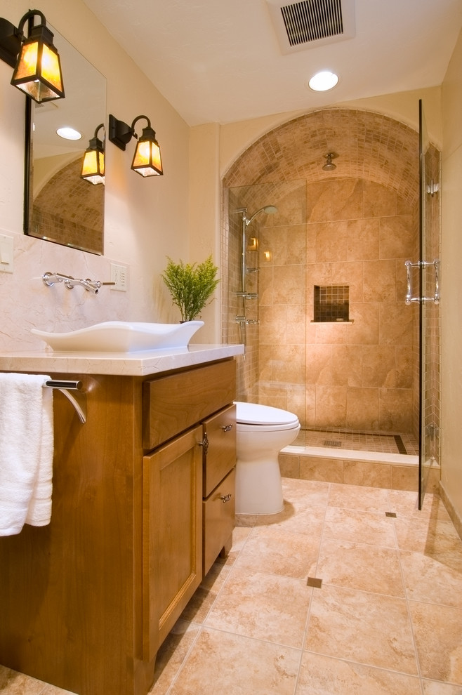 Alcove shower - large contemporary master beige tile and ceramic tile ceramic tile alcove shower idea in Seattle with recessed-panel cabinets, medium tone wood cabinets, a two-piece toilet, beige walls, a vessel sink and granite countertops