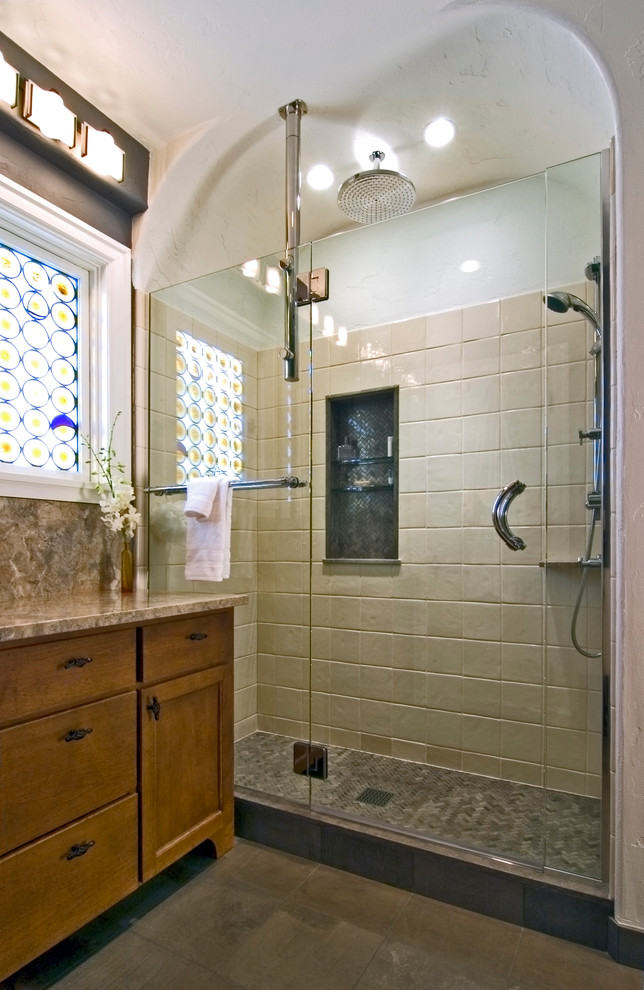 Inspiration for a large contemporary master beige tile and ceramic tile ceramic tile alcove shower remodel in Seattle with recessed-panel cabinets, medium tone wood cabinets, beige walls, a vessel sink and granite countertops