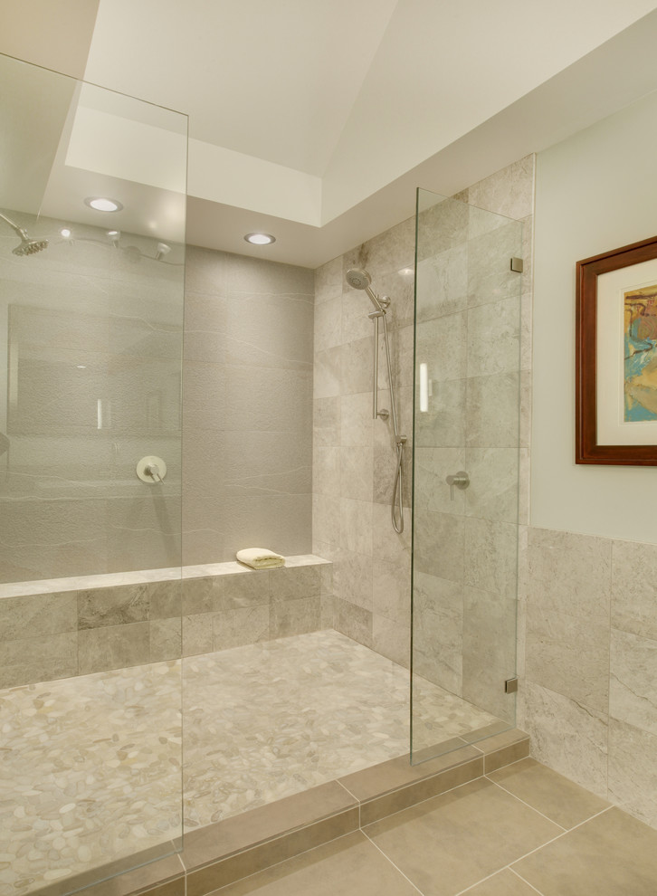 Inspiration for a large modern master stone tile pebble tile floor double shower remodel in Seattle