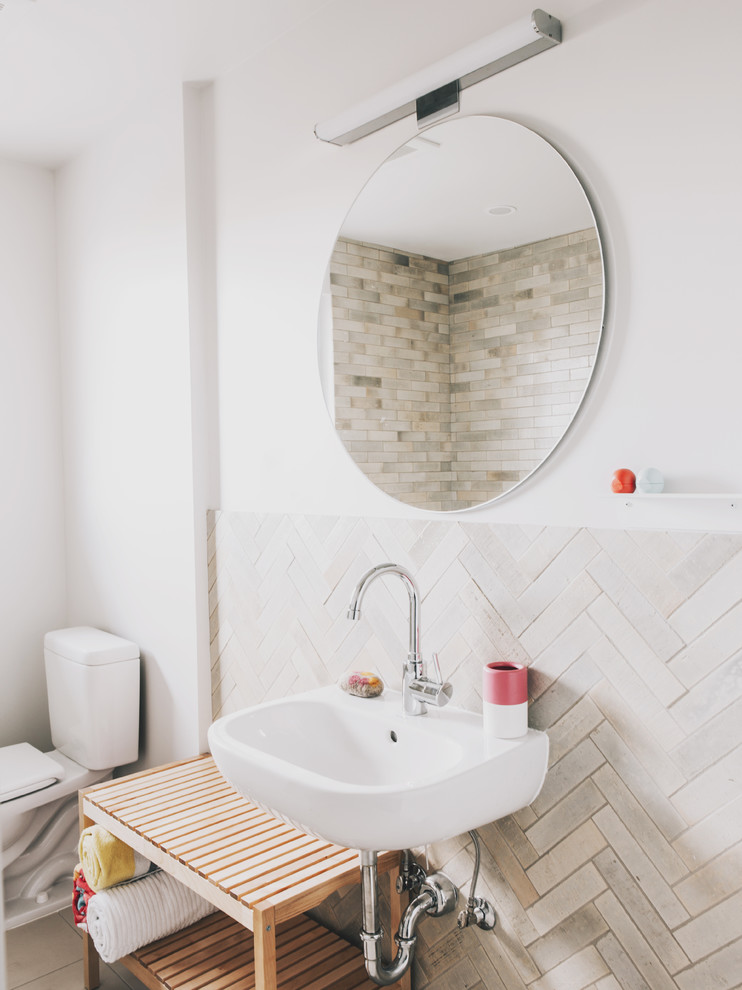 Example of a small 1950s kids' beige tile and ceramic tile porcelain tile tub/shower combo design in Seattle with open cabinets, a two-piece toilet, white walls and a wall-mount sink