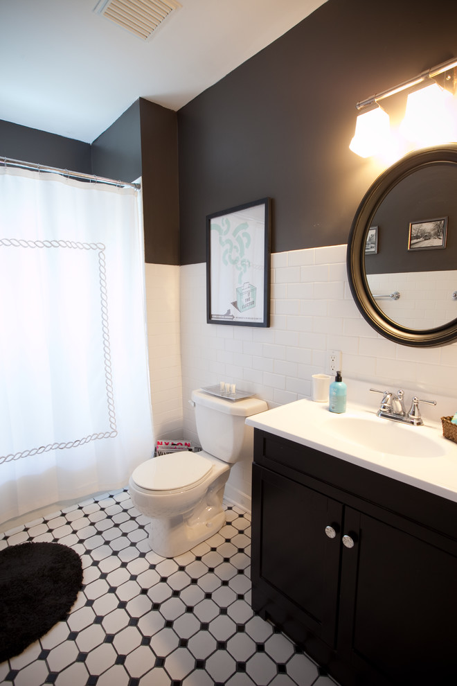Elegant subway tile and black and white tile bathroom photo in Omaha with black walls