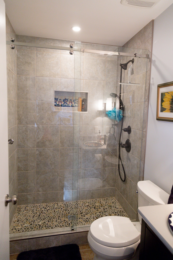 Inspiration for a small rustic master gray tile pebble tile floor alcove shower remodel in Calgary with flat-panel cabinets, a one-piece toilet, a vessel sink and quartz countertops