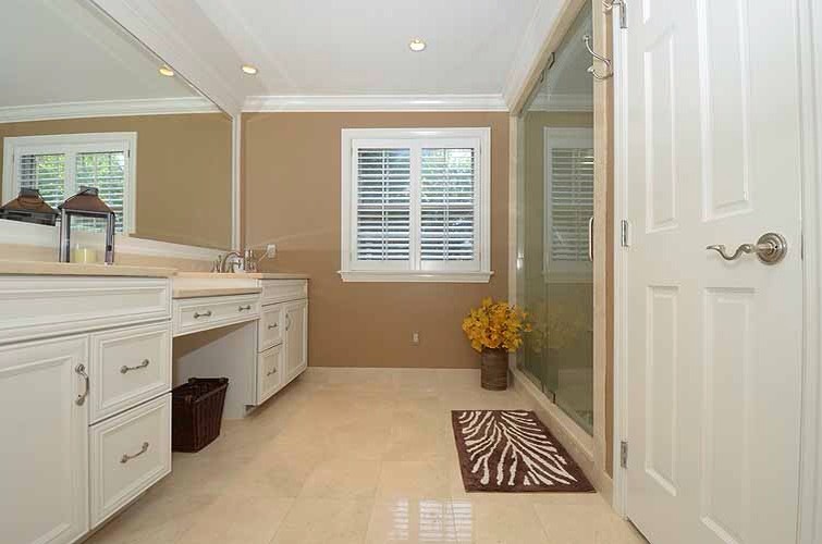 Example of a large classic master beige tile and stone tile limestone floor alcove shower design in Philadelphia with beaded inset cabinets, white cabinets, a two-piece toilet, beige walls, an undermount sink and limestone countertops