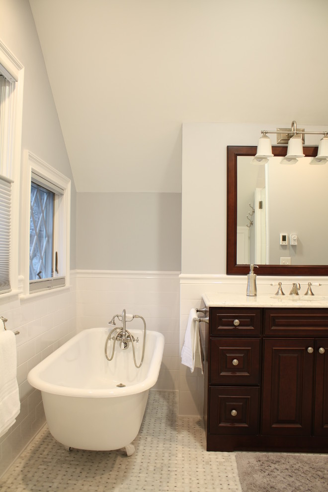Example of a classic master white tile and subway tile mosaic tile floor bathroom design in Boston with an undermount sink, raised-panel cabinets, dark wood cabinets, quartzite countertops, a two-piece toilet and gray walls