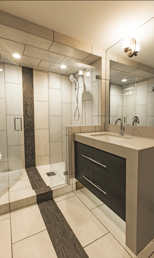 Mid-sized trendy 3/4 beige tile and porcelain tile limestone floor and beige floor bathroom photo in Salt Lake City with flat-panel cabinets, gray cabinets, beige walls, a vessel sink, quartz countertops and a hinged shower door
