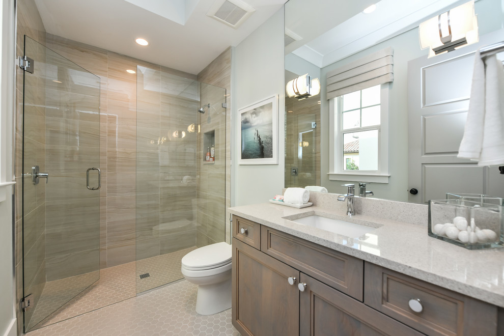 Mid-sized transitional kids' brown tile and porcelain tile porcelain tile and beige floor alcove shower photo in Tampa with recessed-panel cabinets, medium tone wood cabinets, a two-piece toilet, gray walls, an undermount sink and a hinged shower door
