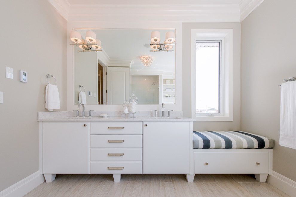 Elegant bathroom photo in Other with an undermount sink and white cabinets
