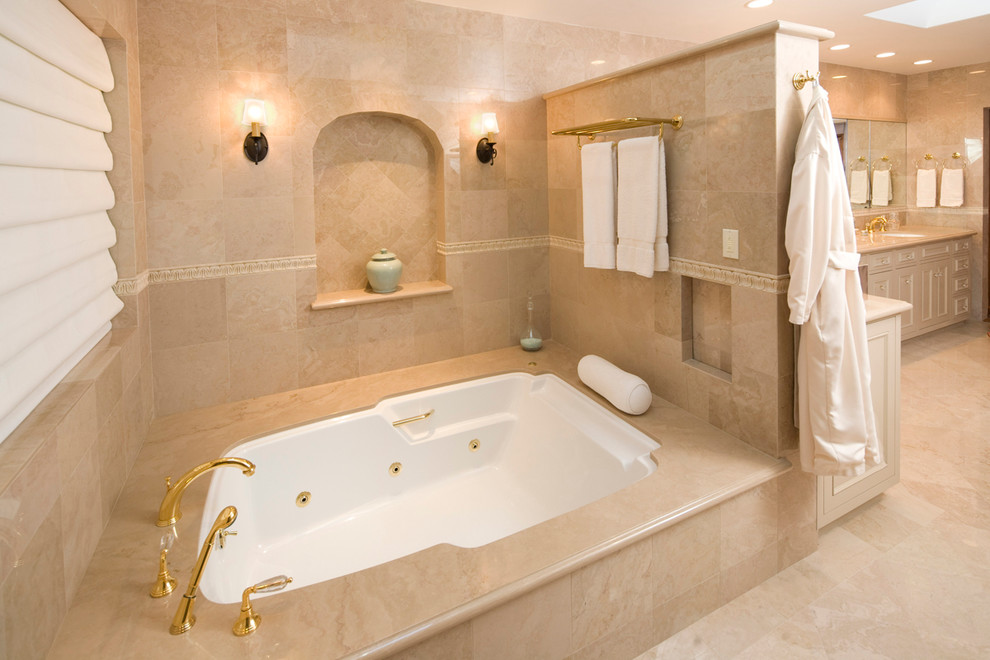 Bathroom - large mediterranean master white tile marble floor bathroom idea in Santa Barbara with an integrated sink, recessed-panel cabinets, white cabinets, a hot tub and beige walls