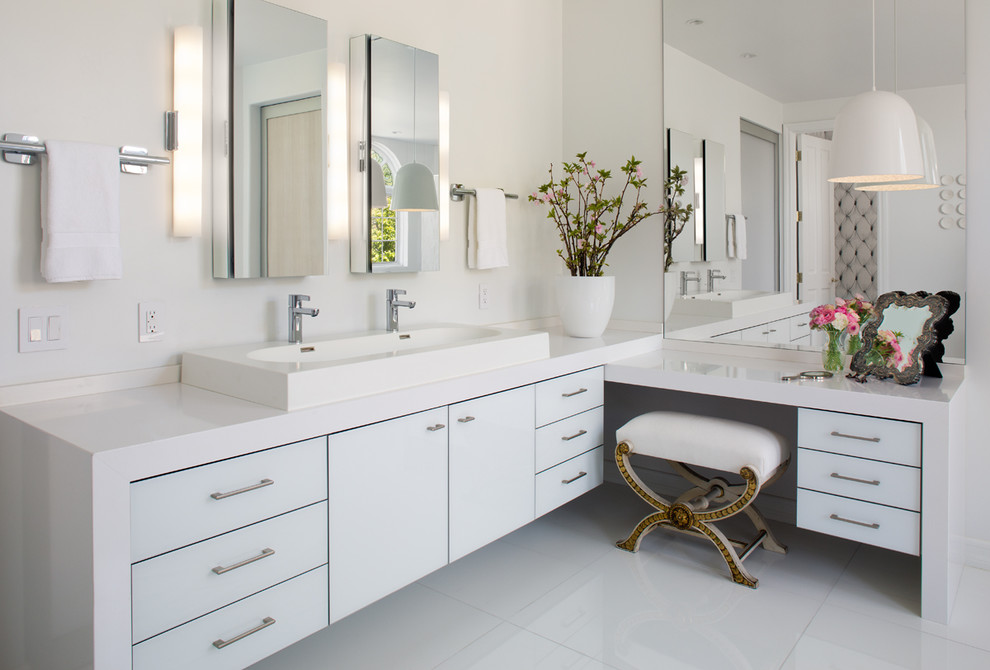 Design ideas for a medium sized contemporary ensuite bathroom in San Diego with a trough sink, flat-panel cabinets, white cabinets, white walls, solid surface worktops, white floors and white worktops.