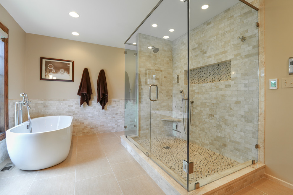 Large transitional master beige tile and stone tile porcelain tile bathroom photo in Chicago with recessed-panel cabinets, dark wood cabinets, beige walls, an undermount sink and limestone countertops