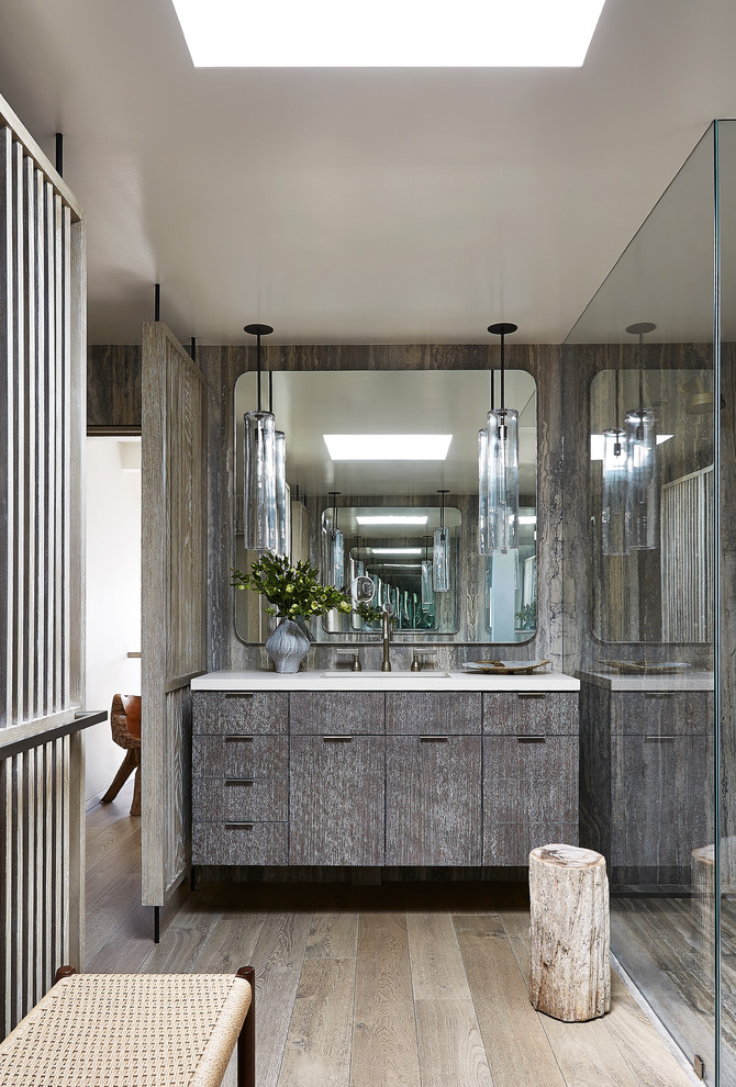 Inspiration for a contemporary shower room bathroom in Los Angeles with flat-panel cabinets, distressed cabinets, a built-in shower, light hardwood flooring and a submerged sink.