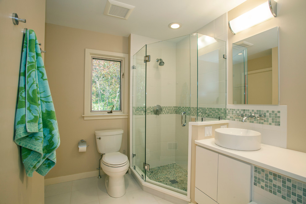 This is an example of a medium sized traditional ensuite bathroom in Philadelphia with a corner shower, a vessel sink, flat-panel cabinets, white cabinets, green tiles, ceramic tiles, beige walls, ceramic flooring, a two-piece toilet and white floors.