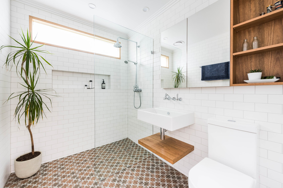 Bathroom - contemporary 3/4 white tile and ceramic tile cement tile floor and multicolored floor bathroom idea in Melbourne with open cabinets, a one-piece toilet, white walls and a wall-mount sink