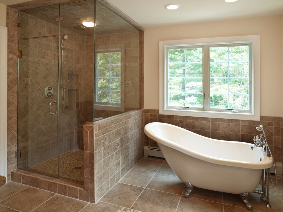 Inspiration for a huge transitional master brown tile and stone tile claw-foot bathtub remodel in Philadelphia with beige walls