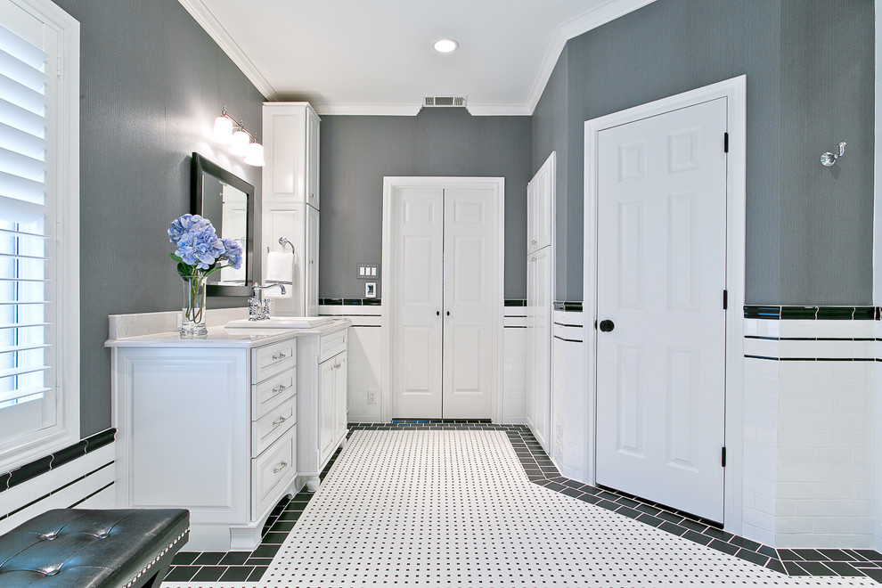 Example of a mid-sized classic master white tile and porcelain tile porcelain tile bathroom design in Dallas with a drop-in sink, furniture-like cabinets, white cabinets, solid surface countertops and a two-piece toilet