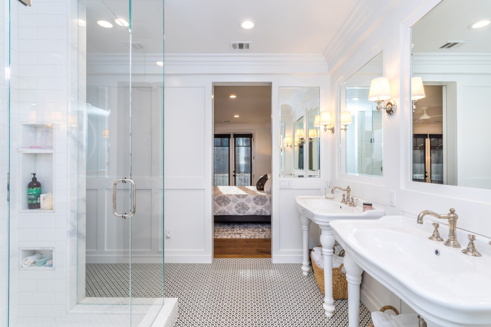 Large beach style master porcelain tile and black floor double shower photo in Los Angeles with a one-piece toilet, a pedestal sink, marble countertops and a hinged shower door