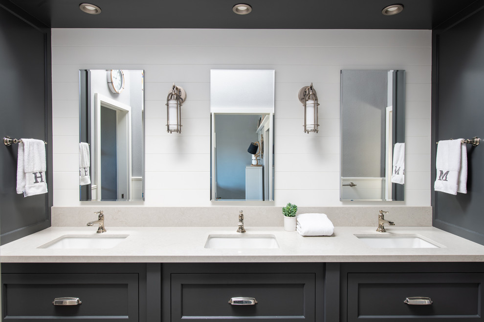 Mid-sized beach style kids' gray tile and cement tile brown floor and wainscoting bathroom photo in Los Angeles with recessed-panel cabinets, gray cabinets, a one-piece toilet, gray walls, an undermount sink, quartzite countertops, white countertops, a niche and a built-in vanity