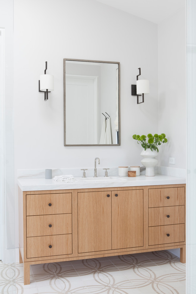 Immagine di una stanza da bagno stile marinaro con lavabo sottopiano, ante in legno scuro, pareti bianche e ante lisce