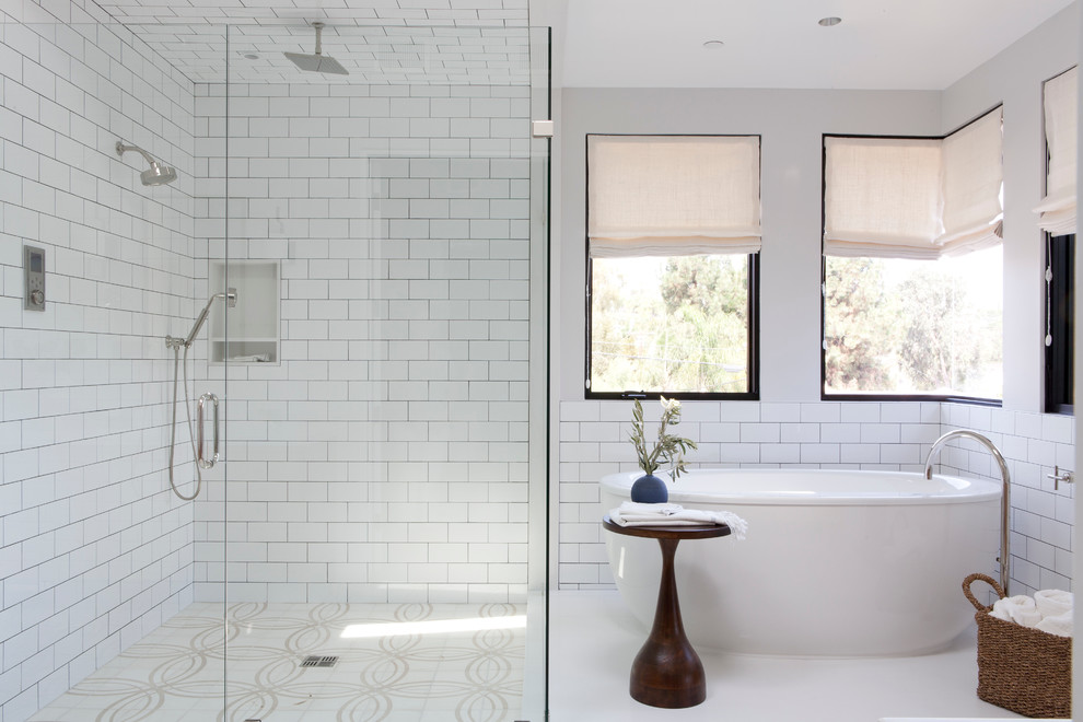 Inspiration for a large beach style bathroom in Los Angeles with a freestanding bath, a corner shower, white tiles, metro tiles and white walls.