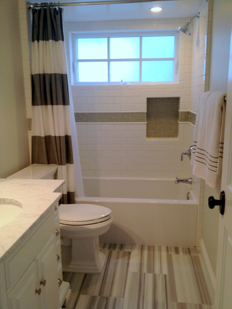 Example of a classic bathroom design in Los Angeles with an undermount sink, white cabinets, marble countertops, a two-piece toilet and gray walls