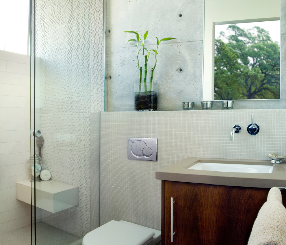 Medium sized modern shower room bathroom in Los Angeles with a wall mounted toilet, flat-panel cabinets, dark wood cabinets, an alcove shower, beige tiles, mosaic tiles, beige walls, a submerged sink, engineered stone worktops and a sliding door.