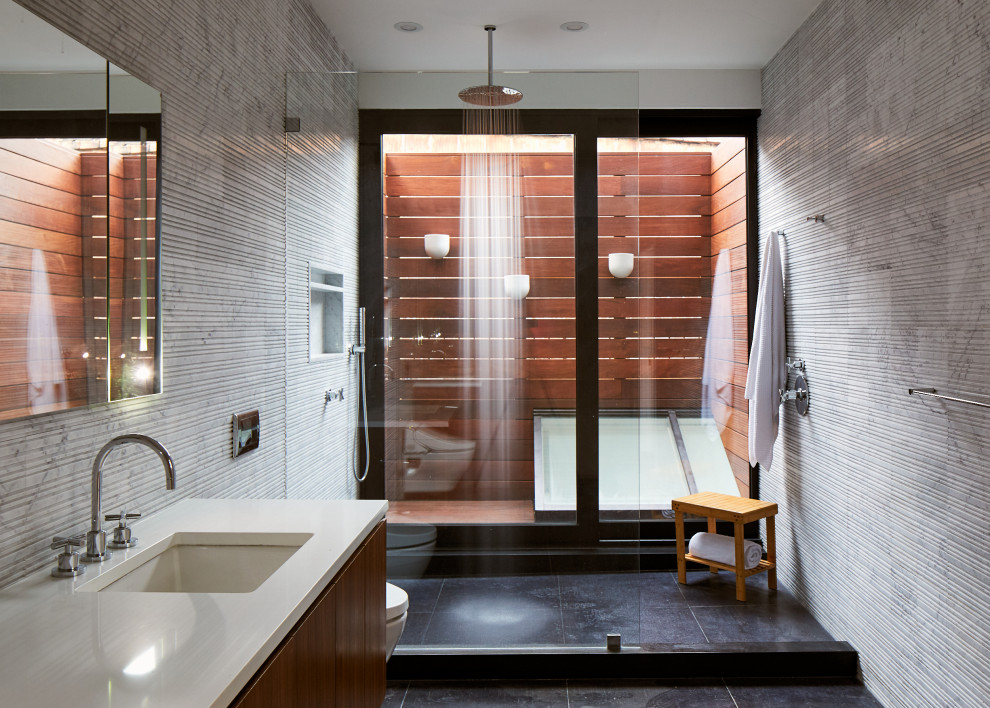 Источник вдохновения для домашнего уюта: большая главная ванная комната в современном стиле с плоскими фасадами, темными деревянными фасадами, серой плиткой, цементной плиткой, серыми стенами, полом из сланца, врезной раковиной, столешницей из искусственного кварца, черным полом, открытым душем, белой столешницей, душем в нише, нишей и подвесной тумбой