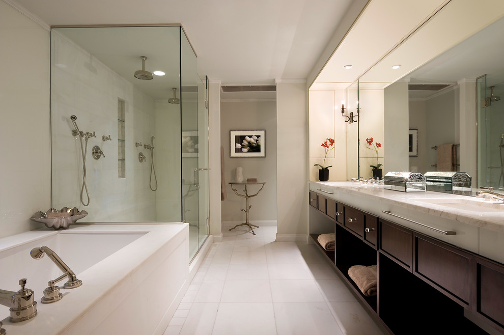 Double shower - modern master marble floor double shower idea in New York with an undermount sink, recessed-panel cabinets, dark wood cabinets, marble countertops, an undermount tub and beige walls