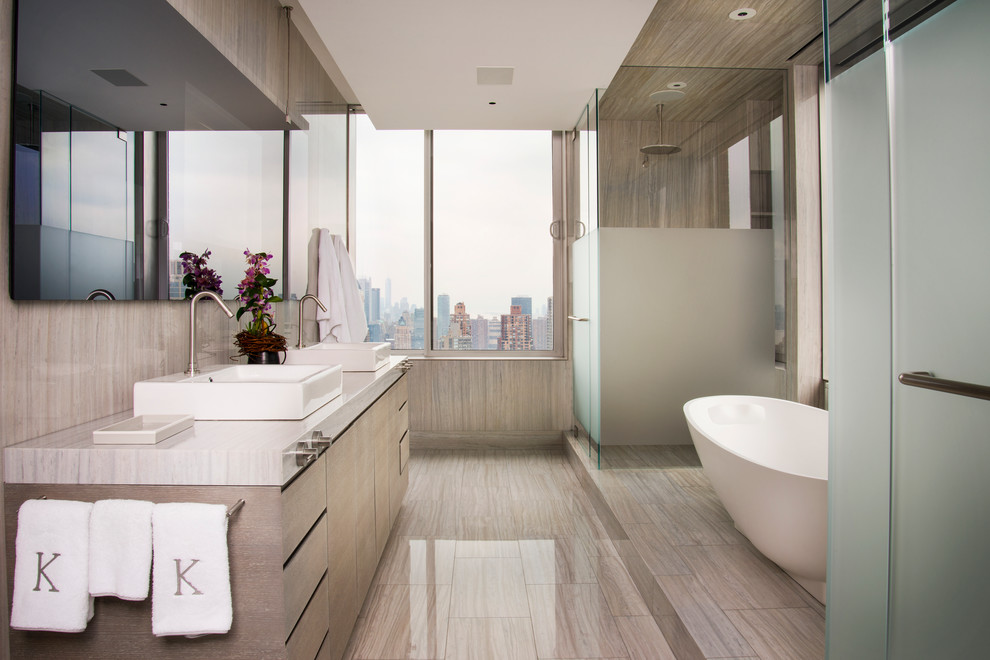 Design ideas for a contemporary ensuite bathroom in New York with flat-panel cabinets, a freestanding bath and a corner shower.