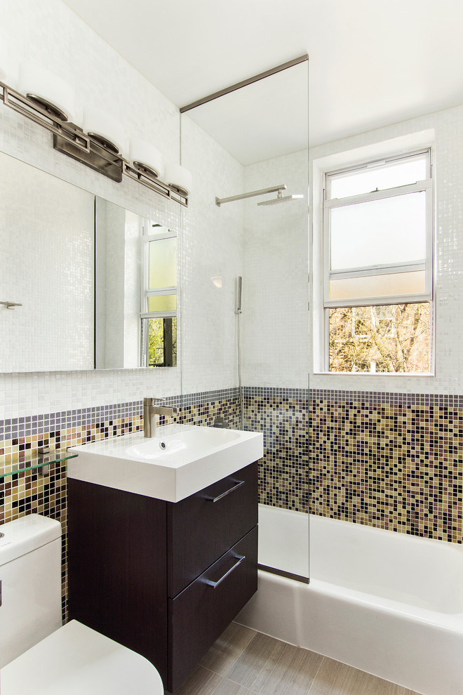 Small minimalist master white tile and glass tile porcelain tile bathroom photo in New York with flat-panel cabinets, dark wood cabinets, a one-piece toilet, white walls and an integrated sink