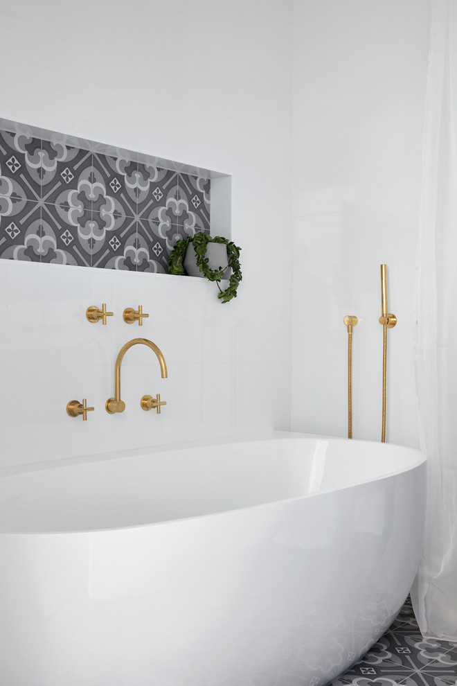 Design ideas for a medium sized classic shower room bathroom in Melbourne with freestanding cabinets, blue cabinets, a freestanding bath, white tiles, white walls, mosaic tile flooring, an integrated sink, laminate worktops, multi-coloured floors and white worktops.