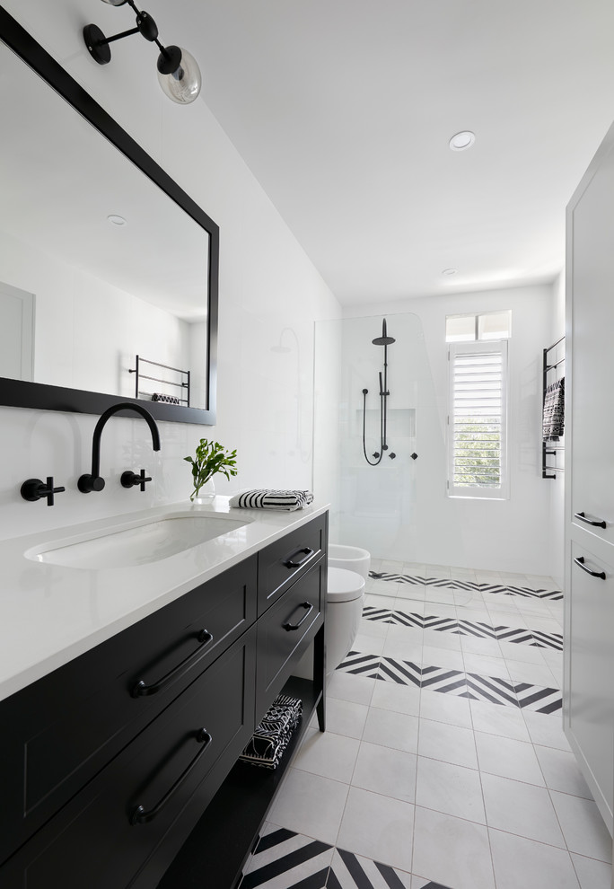 Design ideas for a large traditional ensuite bathroom in Melbourne with raised-panel cabinets, black cabinets, a walk-in shower, a wall mounted toilet, white tiles, ceramic tiles, white walls, mosaic tile flooring, an integrated sink, laminate worktops, a hinged door and white worktops.