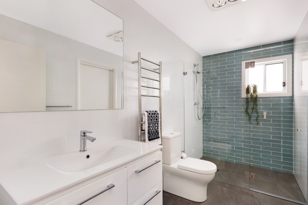 Design ideas for a medium sized contemporary bathroom in Sydney with white cabinets, an alcove shower, a two-piece toilet, multi-coloured tiles, white walls, an integrated sink, engineered stone worktops, brown floors, a hinged door and white worktops.