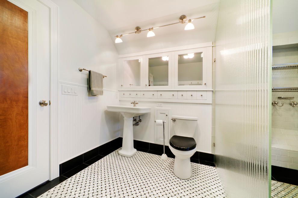 Inspiration for a medium sized classic bathroom in Other with white cabinets, a walk-in shower, a two-piece toilet, white tiles, white walls, a pedestal sink, porcelain flooring, a single sink and wainscoting.