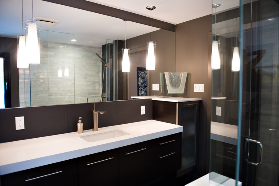 Inspiration for a large modern master gray tile and porcelain tile porcelain tile doorless shower remodel in Toronto with flat-panel cabinets, dark wood cabinets, a one-piece toilet, brown walls, an undermount sink and quartz countertops