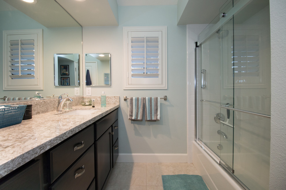 Inspiration for a mid-sized contemporary kids' white tile and subway tile porcelain tile bathroom remodel in Other with recessed-panel cabinets, dark wood cabinets, a two-piece toilet, green walls, an undermount sink and quartz countertops