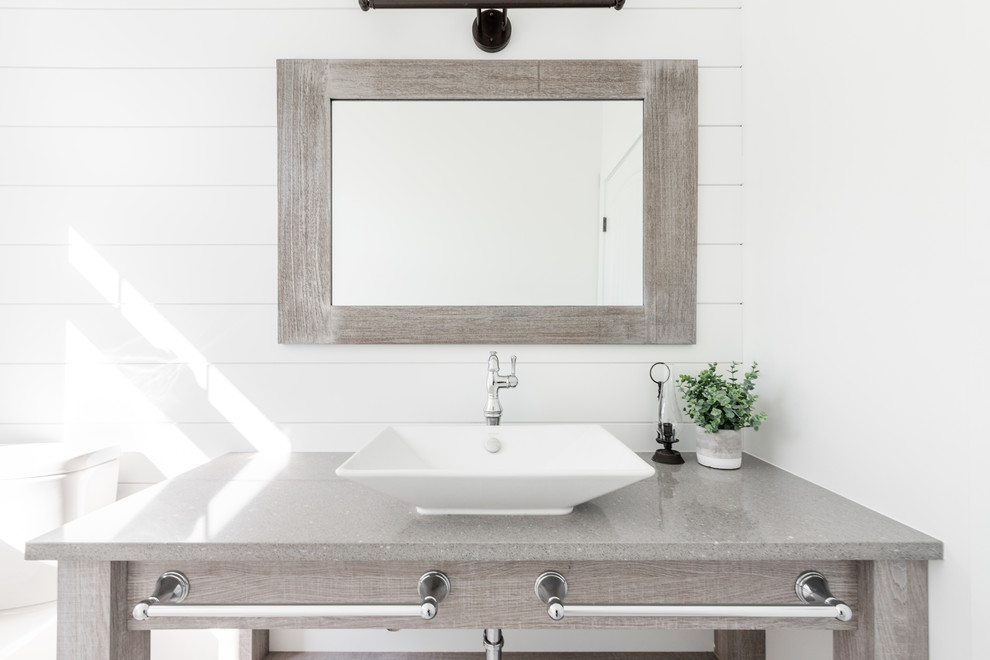 Large farmhouse porcelain tile and white floor bathroom photo in Other with light wood cabinets, a vessel sink, quartz countertops and gray countertops