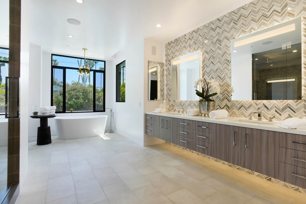 Photo of an expansive contemporary ensuite bathroom in Los Angeles with flat-panel cabinets, brown cabinets, a freestanding bath, an alcove shower, beige tiles, matchstick tiles, white walls, a submerged sink, beige floors, a hinged door and beige worktops.